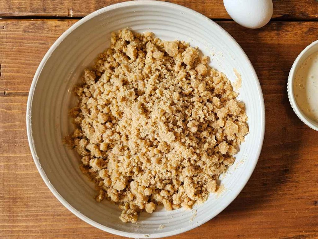 crumble topping for rhubarb crumble cake in a white bowl